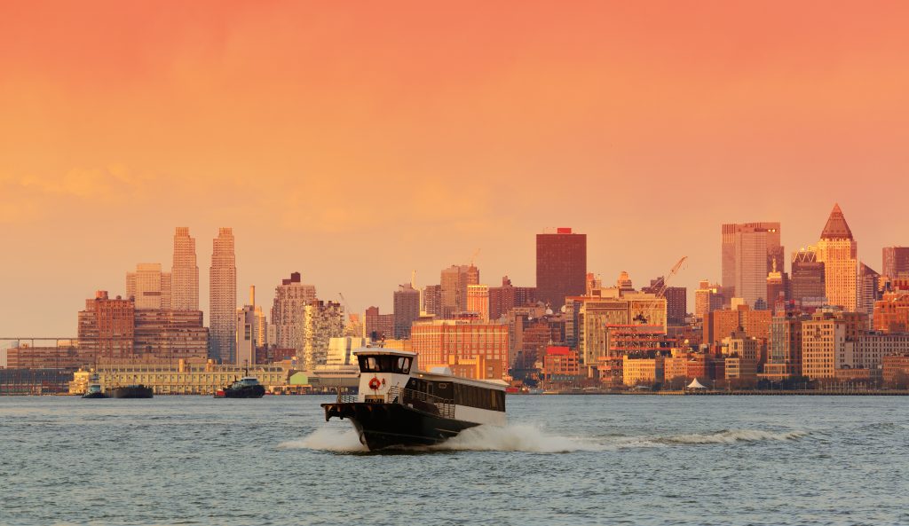 Downtown Manhattan skyline at sunset over Hudson River in New York City