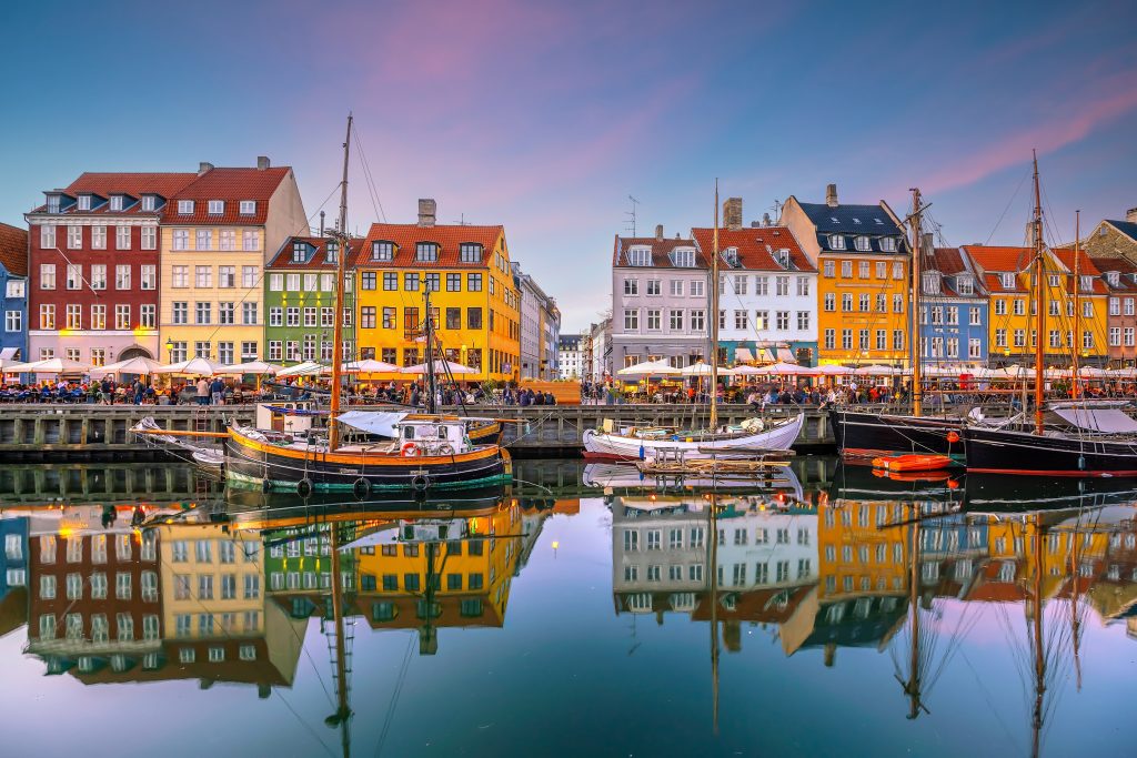 Cityscape of downtown Copenhagen city skyline in Denmark at famous old Nyhavn port at sunset