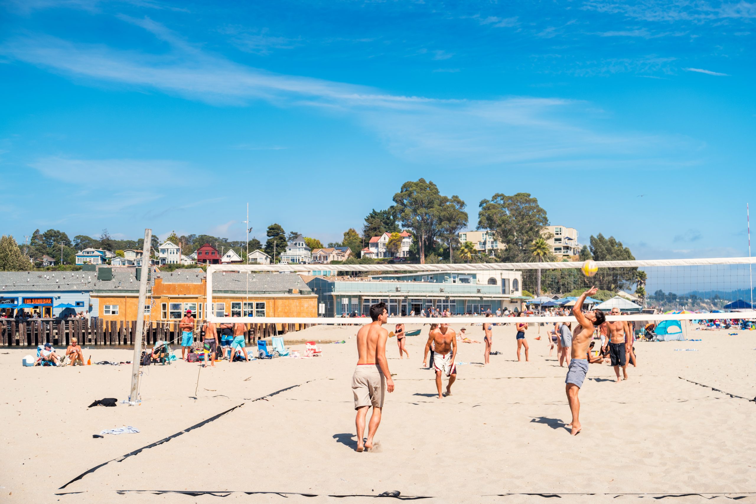 People play beach volleyball on the beach in Capitola, California, USA on a sunny day.